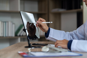 Modern Doctor Examining Results X-Ray on Transparent Monitor Screen