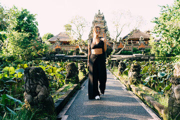 Happy woman admiring view against ancient Water Palace temple in Bali