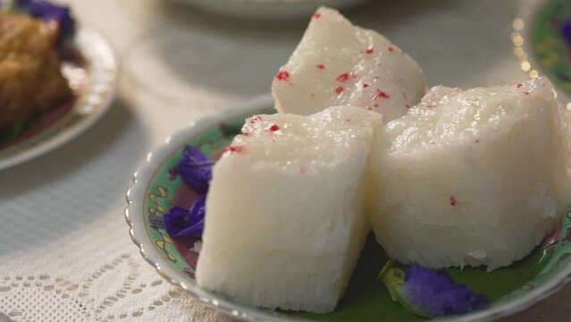 Phuket native desserts, Kanom Pae Tung Koi or Sticky rice cake made from rice flour and white sugar. The texture of the snack is white puffy prunes with red dots on the front.