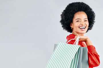 Shopping bag, portrait and young woman for fashion discount, sale and retail promotion on a white background. Gift, giveaway and happy customer, model or african person with mockup space in studio