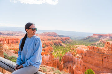 Hiker woman in Bryce Canyon hiking relaxing looking at amazing view during hike on summer travel in...