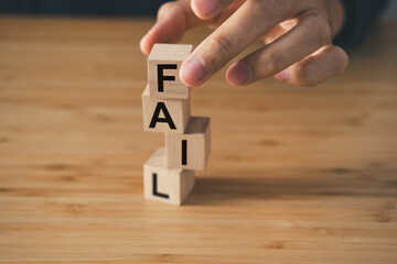 Fail text on wooden cube block on wooden table. business strategy and marketing  concept