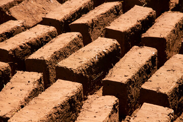 Man building with his hands an adobe house with adobe bricks and mud. Llachon region of Lake...