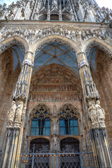 Fototapeta na wymiar Ornate facade of famous medieval architecture, detail. The main gate of Ulm Cathedral