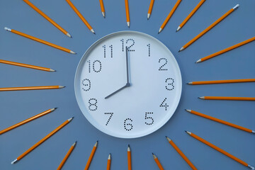 8 o'clock, morning. Study time. Back to school. Watch with white clock face on blue table background with pencils. Concept of study, deadline, schedule. Sun rays