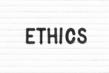 Black color letter in word ethics on white felt board background