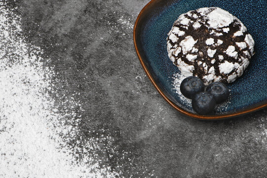 Chocolate crinkle cookies with blueberries and powdered sugar