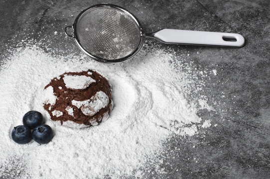 Chocolate crinkle cookies with blueberries and powdered sugar
