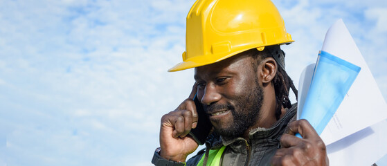 banner of african man construction worker happy talking on the phone celebrating his new contract