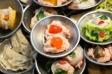Various type of Dim sum, famous chinese appertizer food which are prepared in stainless plate. Raw food menu object photo, close-up and selective at top.