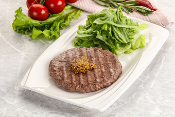 Frilled beef burger cutlet with iceberg