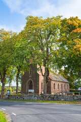 Old country church in autumn colors by a road