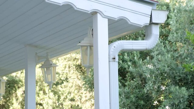 Metallic Guttering System, Guttering, Drainage Pipe Exterior. Drainage on the roof near the shingles
