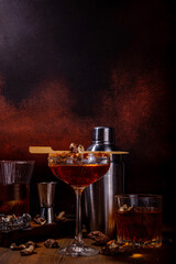 

Trendy hard alcohol mushroom cocktail, booze-free mushroom infused drinks in various cocktail glasses, with bar utensils on dark wooden background copy space