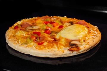 Baked pizza with sausage, mushroom, pepper, mozzarella on tray in electric oven. Italian cuisine, homemade bakery, fast food, cooking concept