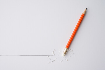 Flat lay of pencil eraser delete black line pencil on white paper background copy space. Repair, remove, creative idea, imagination and education concept.