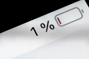 Low level of smartphone charged battery level indicator - one, 1 percent: close up macro view of gadget display, screen. Energy, technology, power, digital and symbol concept