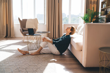 Middle aged woman relaxing on floor in living room