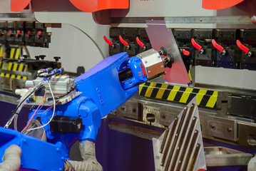 Close up the sheet metal bending process by robotic arm.