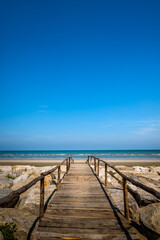 Wooden bridge walkway to the sea beach