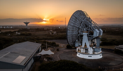 Aerial view of satellite dishes at sunset