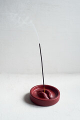 Incense stand red lips. Round shape on a white background. Esotericism, meditation