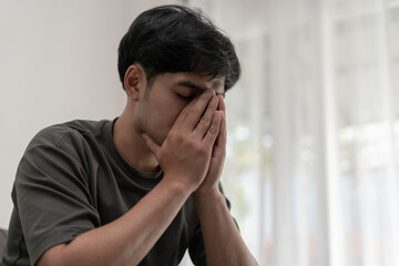 Fototapeta na wymiar Depression and mental illness. Asian man disappoint, sad after receive bad news. Stressed boy confused with unhappy problem, arguing with girlfriend, cry and worry about unexpected work, down economy.