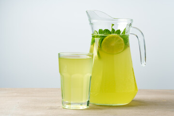 Glass jar of fresh lemonade on table close up