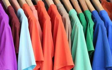 Vibrant Fashion Selection: Colorful T-Shirts Hanging on a Hanger, Showcasing Trendy and Versatile Clothing Options