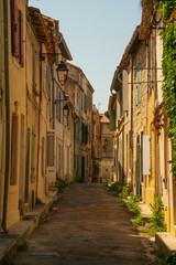 Fototapeta na wymiar Street of old town of Arles, south France, mediterranean architecture, colourful buildings