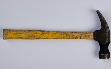 A yellow old hammer on a white background. AI generative
