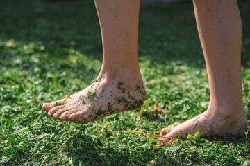 The concept of summer, ecology. unity with nature. bare feet in the grass