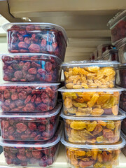 Freeze-dried cherries and raisins in plastic containers in the supermarket
