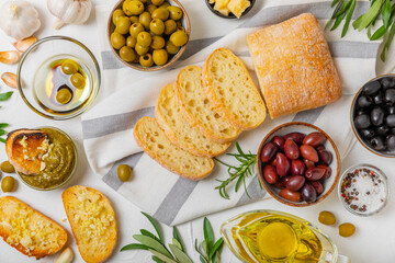 Bruschetta with olive oil, olives, pesto, garlic and parmesan. ciabatta bread with olive oil and spices. Delicacy. Delicious and healthy food. Vegan. Place to copy. copy space.