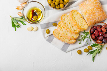 Bruschetta with olive oil, olives, pesto, garlic and parmesan. ciabatta bread with olive oil and...