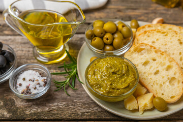 Bruschetta with olive oil, olives, pesto, garlic and parmesan. ciabatta bread with olive oil and spices. Delicacy. Delicious and healthy food. Vegan. Place to copy. copy space.