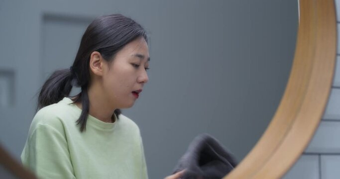 욕실에서 세수한 다음 수건으로 얼굴을 닦는 여성