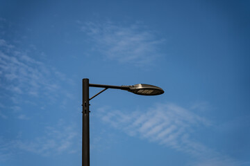 LED street lights turned off on a background of midday blue sky