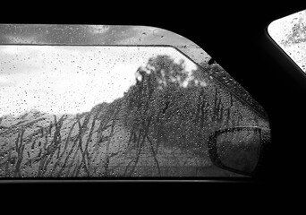 Rainny mood , Raindrops on the car rearview mirror. Heavy rain outside.