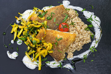 cod fish fillet on pearl barley rice, saffron zucchini, white wine foam and fresh herbs italian...