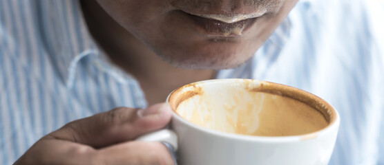 Close up man drinking coffee in Coffee shop