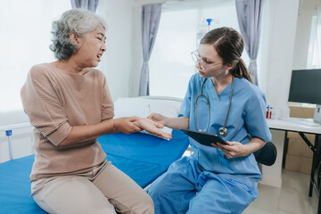 Young beautiful smiling doctor nurse caring to help happy senior grandmother helping old patients in rehabilitation at elderly health checkup