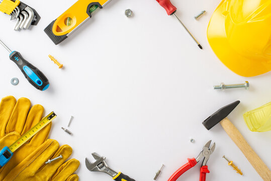 Labor Day celebration with construction professionals: top-view shot, featuring helmet, gloves, and building instruments on white isolated background. Ideal for Labor Day content, promotions, or ads