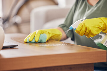 Hands, gloves and cleaning service a table in a home with safety from germs or dirt. Cleaner, dust...
