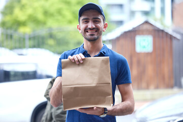 Happy man, portrait and paper bag for delivery, supply chain or transport of goods in courier service. Friendly male person with parcel, package or cargo for online order, purchase or ecommerce