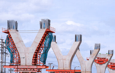 Cast Iron formwork for installing large concrete columns structure of elevated Expressway in under construction against white cloudy sky background