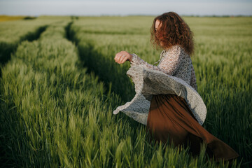 Curly girl dancing on the field