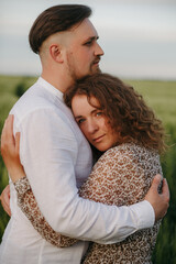 Couple in love on green field of wheat