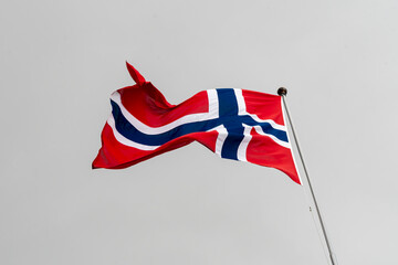 Norway flag flying against plain cloud background