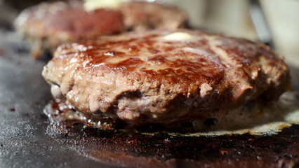 Macro shot of roasting juicy burger patties on grill at kitchen. Cooking at home, kitchen appliance, healthy nutrition, hamburger ingredients.